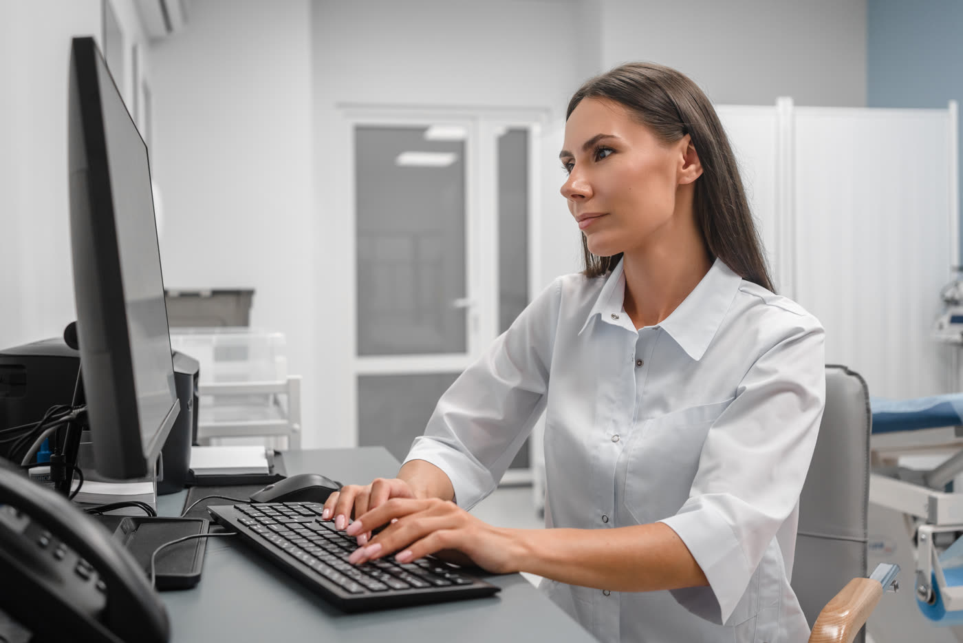 A clinic staff member working at a computer